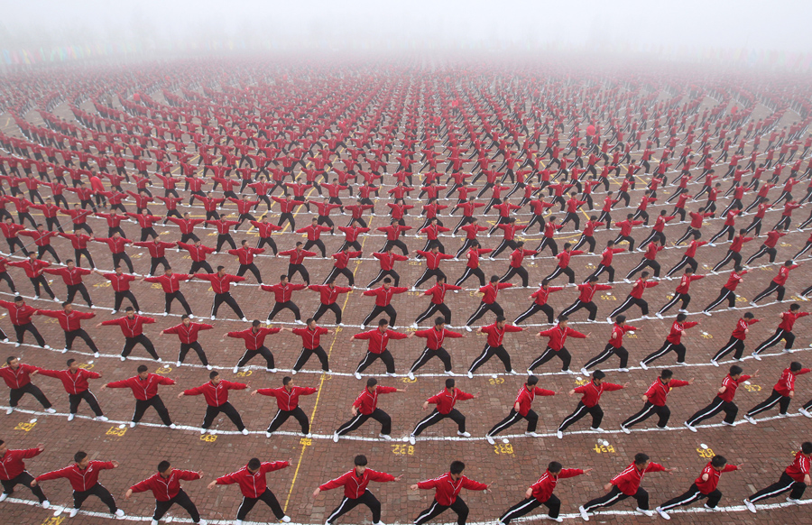 Students perform during a founding ceremony of a football team of Shaolin Tagou martial arts school, in Dengfeng
